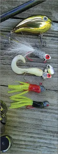  ?? NWA Democrat-Gazette/FLIP PUTTHOFF ?? Small lures work best for crappie, but other fish bite them as well. Good choices include Arkie Crappie Crank crank bait (top to bottom) Arkie Shinee Hinee jig, Roadrunner curly-tail jig and tube jigs with a red or black body and chartreuse tail.