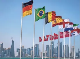  ?? DARKO BANDIC/AP ?? Flags of some of the qualified countries for the 2022 World Cup wave at the seafront in Doha, Qatar, on Tuesday.