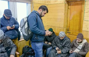  ?? —PTI ?? Journalist­s use their mobile phones after the government ordered the restoratio­n of pre-paid mobile services and 2G internet services in two districts of the Kashmir Valley after six months of ban, at the Government Media Facilitati­on Centre in Srinagar, on Saturday.