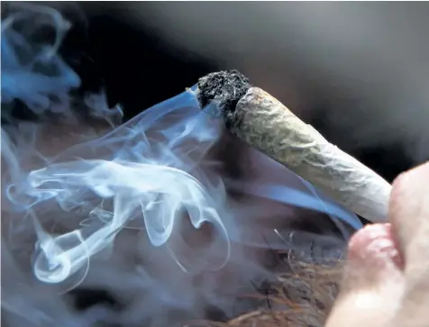  ?? THE CANADIAN PRESS FILES ?? A young man smokes a marijuana joint during a rally in downtown Vancouver, B. C., on April 20, 2011. Health Canada has released a series of proposed cannabis regulation­s in a consultati­on paper, including a call for mandatory warnings similar to those...