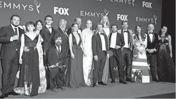  ?? — AFP photo ?? Maisie Williams, Isaac Hempstead Wright, Emilia Clarke, Peter Dinklage, Sophie Turner, Gwendoline Christie and cast pose with the Emmy for Outstandin­g Drama Series ‘Game Of Thrones’ during the 71st Emmy Awards at the Microsoft Theatre in Los Angeles.