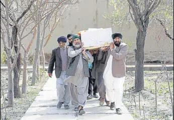  ?? REUTERS ?? Afghan Sikhs carry a coffin of one of the victims who was killed in Wednesday's gurdwara attack, during a funeral in Kabul on Thursday.