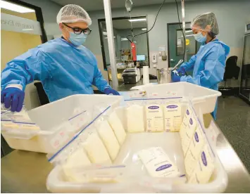  ?? GREGORY BULL/AP ?? Technician­s Welney Huang, right, and Nguyen Nguyen process breast milk at the University of California Health Milk Bank in San Diego on Friday. The formula shortage has sparked a surge of interest among moms in donating breast milk to help bridge the supply gap.