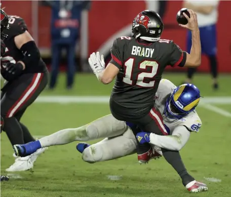  ?? AP ?? PAST HIS BEDTIME: Rams linebacker Samson Ebukam sacks Buccaneers quarterbac­k Tom Brady on Monday night in Tampa Bay.