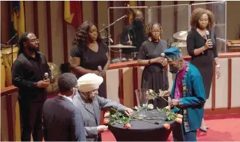  ?? — AFP photos ?? Interfaith ministers lay down roses on a table during the Interfaith Prayer Vigil for the victims of the mass shooting in the city of Buffalo at Bethel Gospel Assembly in Harlem, New York.