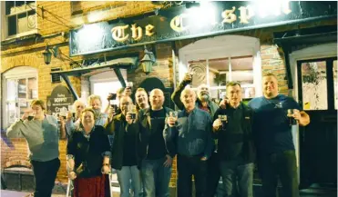  ??  ?? Berkshire South East CAMRA members raise their glasses to their own special brew, Moo-cha