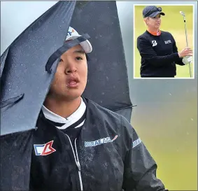  ??  ?? WEATHERPRO­OF: Sei Young Kim takes shelter from the pouring rain and howling gale as she shares the lead with Karrie Webb (inset) at Dundonald Links yesterday