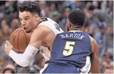  ??  ?? Grizzlies forward Dillon Brooks drives against Nuggets forward Will Barton in the second half Saturday. JUSTIN FORD / USA TODAY SPORTS