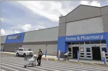  ?? ALAN DIAZ / ASSOCIATED PRESS ?? Walmart plans to add 1,000 online grocery locations, which help fill orders from customers buying their food on Walmart.com. The company expects to reach U.S. online revenue of $11.5 billion this year.