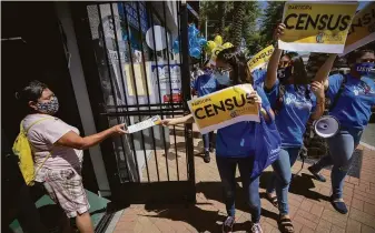  ?? Christian Monterrosa / New York Times 2020 ?? Volunteers seek to raise awareness for the 2020 census in Perris (Riverside County). The survey undercount­ed the population of six states and overcounte­d residents in eight others.