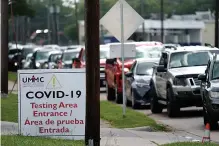  ?? Associated Press ?? ■ People wait inside their vehicles in line at a COVID-19 testing site Wednesday in Houston. Texas has surpassed 10,000 new coronaviru­s cases in a single day for the first time as a resurgence of the outbreak rages across the U.S. The record high of 10,028 confirmed cases Tuesday follows Republican Gov. Greg Abbott decision to mandate masks in much of the state and to close bars, retreating from what had been one of America’s fastest reopenings.