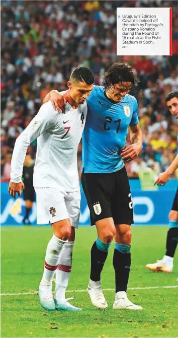  ?? AFP ?? Uruguay’s Edinson Cavani is helped off the pitch by Portugal’s Cristiano Ronaldo during the Round of 16 match at the Fisht Stadium in Sochi.