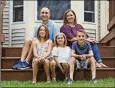  ?? ADAM CAIRNS / THE
COLUMBUS DISPATCH ?? Kara Schooley, 39, and her husband Kurt Schooley, 42, along with their kids, from left, Amelia, 10, Parker, 6, and Bennett, 10, sit outside their house in Hilliard.