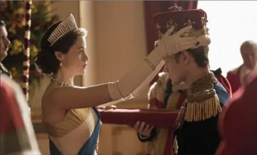  ?? ROBERT VIGLASKY, NETFLIX ?? Claire Foy’s Elizabeth formally makes Matt Smith’s Philip a British Prince in Season 1 of “The Crown.”
