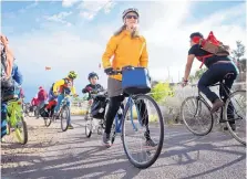  ?? MARLA BROSE/JOURNAL ?? Karla Koch center and her son, Kadroma Saari, 4, head south on the North Diversion Channel Trail during the May 2017 Bike to Work Day.