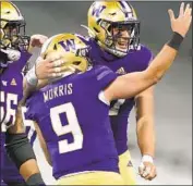  ?? Ted S. Warren Associated Press ?? DYLAN MORRIS greets his Washington teammate Cade Otton after their game-winning score.