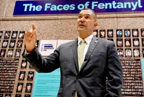  ?? ?? Donovan stands in front of “The Faces of Fentanyl” wall, which displays photos of Americans who died of a fentanyl overdose, at the DEA headquarte­rs in Arlington, Virginia.