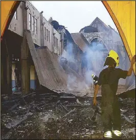  ?? RAYMUND CATINDIG ?? Firemen inspect the rubble after a fire that hit St. Joseph’s parish in Tabuk, Kalinga yesterday.