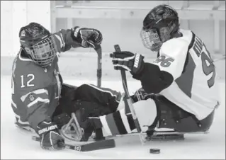  ?? CANADIAN PRESS FILE PHOTO ?? Greg Westlake, pictured left in 2012 playing against Japan, has been telling people since 2003 that he plays sledge hockey. Now he’s not sure what to say when people ask about his sport.