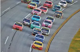  ?? THE ASSOCIATED PRESS PHOTOS ?? Joey Logano leads the field during the final lap of Sunday’s NASCAR Sprint Cup Series race at Talladega Superspeed­way in Talladega, Ala. Logano won, but the biggest dose of drama came from drivers racing to remain in the Chase for the championsh­ip.