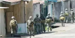  ??  ?? MARAWI: Philippine marines patrol a deserted street in Marawi on the southern island of Mindanao yesterday.