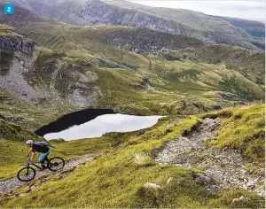  ??  ?? 1 Shot of the
month Night riding pics don’t come much more epic than this clear, starry night in North Wales, taken by Aaron Crowe
2 Robin Woodburn giving his new Canyon Strive a hammering down Nan Bield Pass in the Lake District