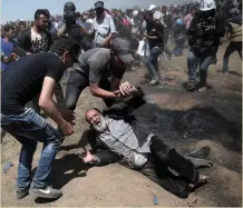  ??  ?? An elderly Palestinia­n man falls to the ground after being shot by Israeli troops during a protest at the Gaza Strip’s border with Israel on Monday. Photo: Adel Hana/AP