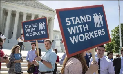 ??  ?? In this June 25, file photo, people gather at the Supreme Court awaiting union dues case, Janus vs. AFSCME, in Washington. AP PHOTO/J. SCOTT APPLEWHITE
