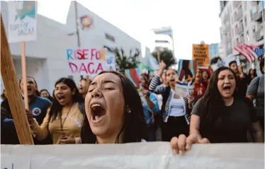  ?? Mario Tama/Getty Images ?? Discover Bank will pay $979,500 to settle a Bay Area suit by DACA recipients who said the bank denied them loans because they were under 16 and undocument­ed when they entered the United States.