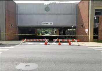  ?? ALEX ROSE — DIGITAL FIRST MEDIA ?? Access to the county’s juror’s parking garage was blocked off Friday after the collapse of a wall inside the structure.