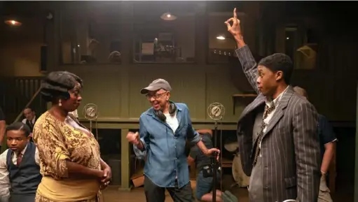  ?? David Lee/Netflix ?? From left, Viola Davis as Ma Rainey, director George C. Wolfe and Chadwick Boseman as Levee on the Pittsburgh set of “Ma Rainey’s Black Bottom,” adapted from the August Wilson play.