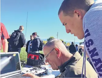  ?? MADDY HAYDEN/JOURNAL ?? West Mesa High School senior Tyler Pittman works with JROTC naval science instructor Mark Hendricks during the Near Space Challenge on Tuesday morning at West Mesa High School. Twenty-eight schools participat­ed in the competitio­n, which involved a...