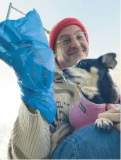  ?? JONO WAKS/AP ?? Jono Waks of Brooklyn with his dog, Millie. Waks recycles his plastic newspaper wrappers to clean up after his dog.