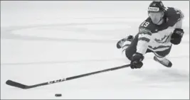  ?? PETR DAVID JOSEK, THE ASSOCIATED PRESS ?? Canada’s Mike Matheson dives for the puck during a 5-0 win Monday over Norway in Paris.