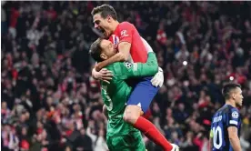  ?? Photograph: David Ramos/Getty Images ?? ▲ Atlético Madrid’s Cesar Azpilicuet­a embraces Jan Oblak after his penalty shootout heroics.