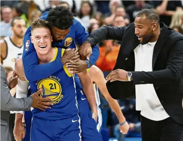  ?? — AP ?? Sheer joy: Golden State Warriors’ Jonas Jerebko (No. 21) celebrates after scoring the winning shot against the Utah Jazz, with teammates Jordan Bell (rear) and DeMarcus Cousins (right) in their NBA game on Friday.