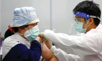  ?? Photograph: Daniel Ceng Shou-Yi/Zuma/Rex/Shuttersto­ck ?? A woman receives the Moderna vaccine at a train station in Taipei, Taiwan.