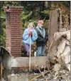  ?? AP ?? A resident searches for heirlooms at her parents’ home destroyed by the California Camp Fire on Dec 4.