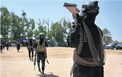  ?? Farah Abdi Warsameh / AP Photo ?? Somali soldiers prepare to secure the capital city of Mogadishu on the eve of presidenti­al elections yesterday.