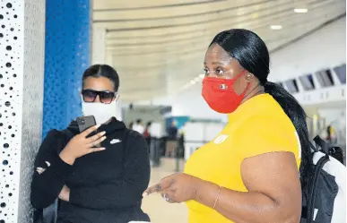  ?? PHOTO BY JANET SILVERA ?? Kidnap hoaxer Kalina Collier (left), who spawned a viral rumour that she was being held hostage at a Jamaican hotel, is seen beside her Jamaica-born mom Candace Walker, who drove her to the Sangster Internatio­nal Airport in Montego Bay to catch her flight to New York on Sunday.