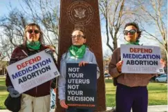  ?? AP PHOTO/DAVID ERICKSON ?? On Wednesday, three members of the Women’s March protest in support of abortion medication access outside the Federal Courthouse in Amarillo, Texas.