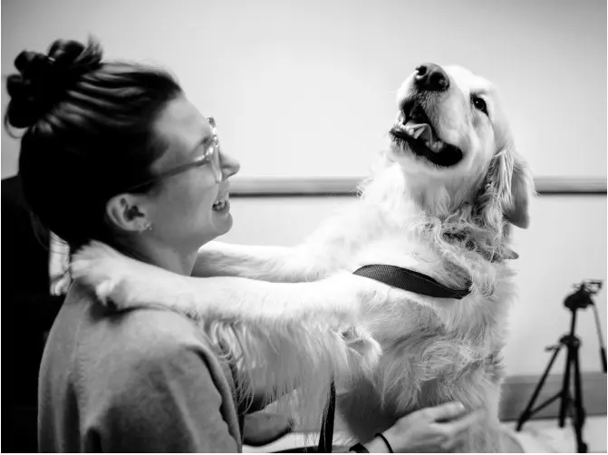  ?? AP PHOTOS ?? Julia Espinosa pets Loki after a job well done. Like many researcher­s and volunteers at the lab, Espinosa is a dog lover. When she was 12 years old, her parents wouldn’t let her have a dog, so she started a dog-walking business.