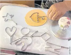  ?? ?? Vendor Lim Chang-joo stamps an umbrella shape onto a dalgona, a crisp sugar candy featured in the Netflix smash hit series Squid Game, for which he and his wife Jung Jung-soon were hired to prepare on the set.