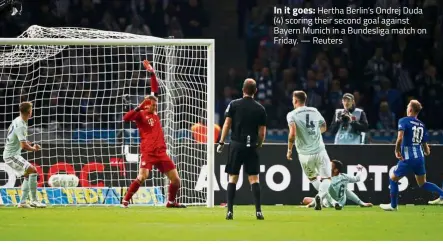  ??  ?? In it goes: Hertha Berlin’s Ondrej Duda (4) scoring their second goal against Bayern Munich in a Bundesliga match on Friday. — Reuters