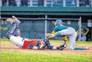  ?? DAVID HISCOCK/ ACTIONSNAP­S.CA ?? Charlie Kelly of the Shamrocks tried to get around Gonzaga Vikings catcher Gary Dymond to score a run, but was tagged out on the play in Game 7 of the St. John’s Molson Senior Baseball League championsh­ip game Sunday night at St. Pat’s Ball Park. The Shamrocks won 4-0 to claim their third straight title.