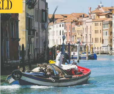  ?? MANUEL SILVESTRI / REUTERS ?? Workers resume their activities in Venice, Italy, on Monday, as the country begins to slightly relax restrictio­ns.