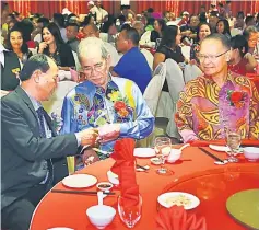  ??  ?? Wan Junaidi (centre) in a discussion with Engachok, as Bolly (right) looks on. — Photo by Muhammad Rais Sanusi