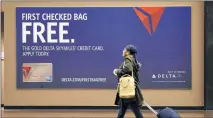  ?? ASSOCIATED PRESS FILE ?? Passengers who get the credit card of the airline they usually fly can enjoy benefits such as priority boarding and free bag-checking, even on so-called basic economy tickets.