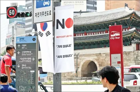  ??  ?? A banner featuring ‘No. Boycott Japan’ is seen hanging on a lamppost in Seoul.