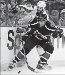  ?? [CHRIS O’MEARA/THE ASSOCIATED PRESS] ?? Tampa Bay Lightning right wing J.T. Brown, front, checks Washington Capitals left wing Daniel Winnik into the boards during the third period Saturday in Tampa, Fla.